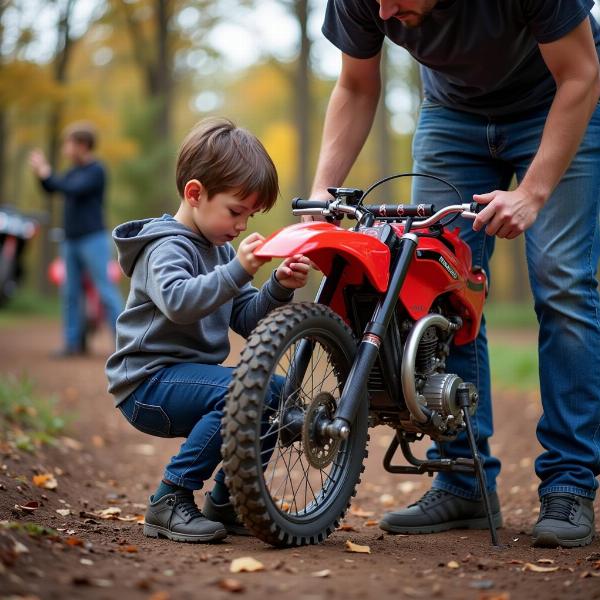 Un enfant vérifiant la pression des pneus de sa moto à essence.