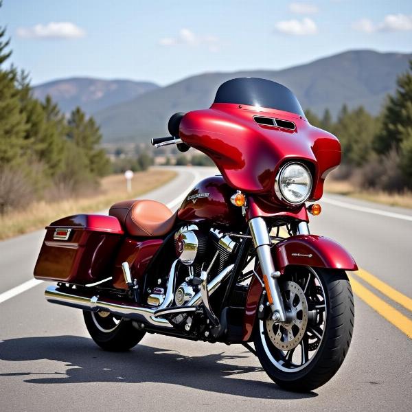 Harley Davidson custom bagger rouge avec sacoches en cuir et pare-brise