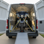 Moto sanglée dans un fourgon, rampe déployée, ambiance garage, lumière naturelle